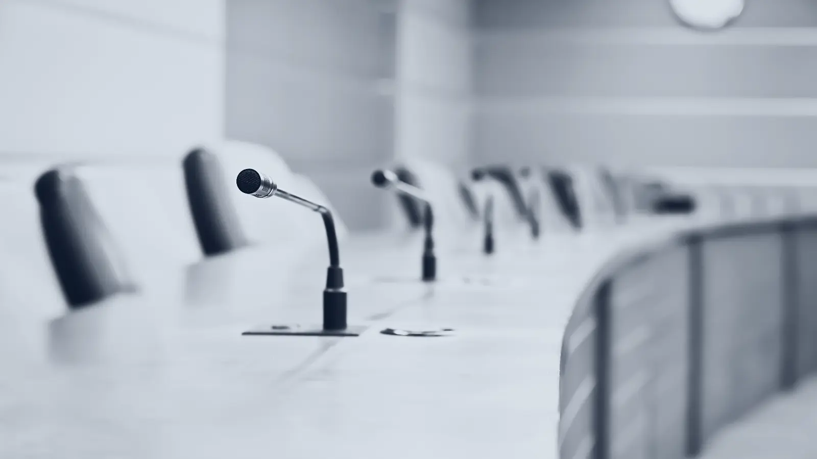 Microphones set along a boardroom table before a session.