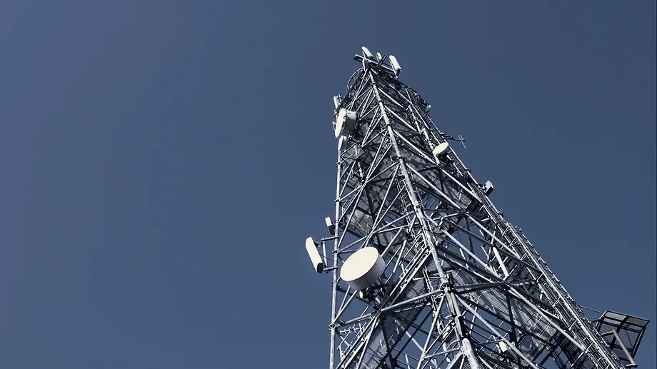 A telecommunications tower against open sky.