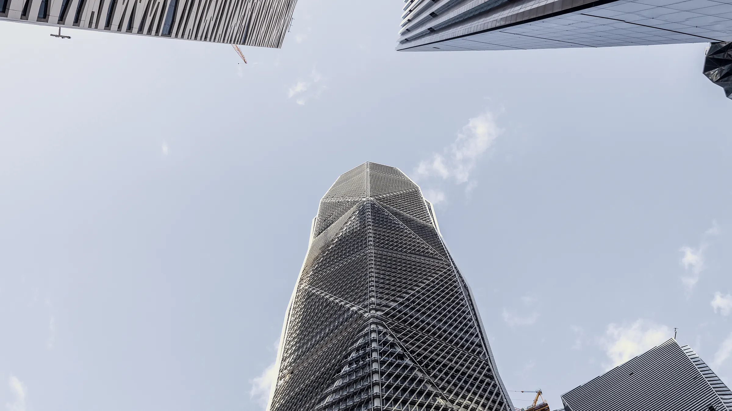 A tower in the King Abdullah Financial District seen from its base against open sky.